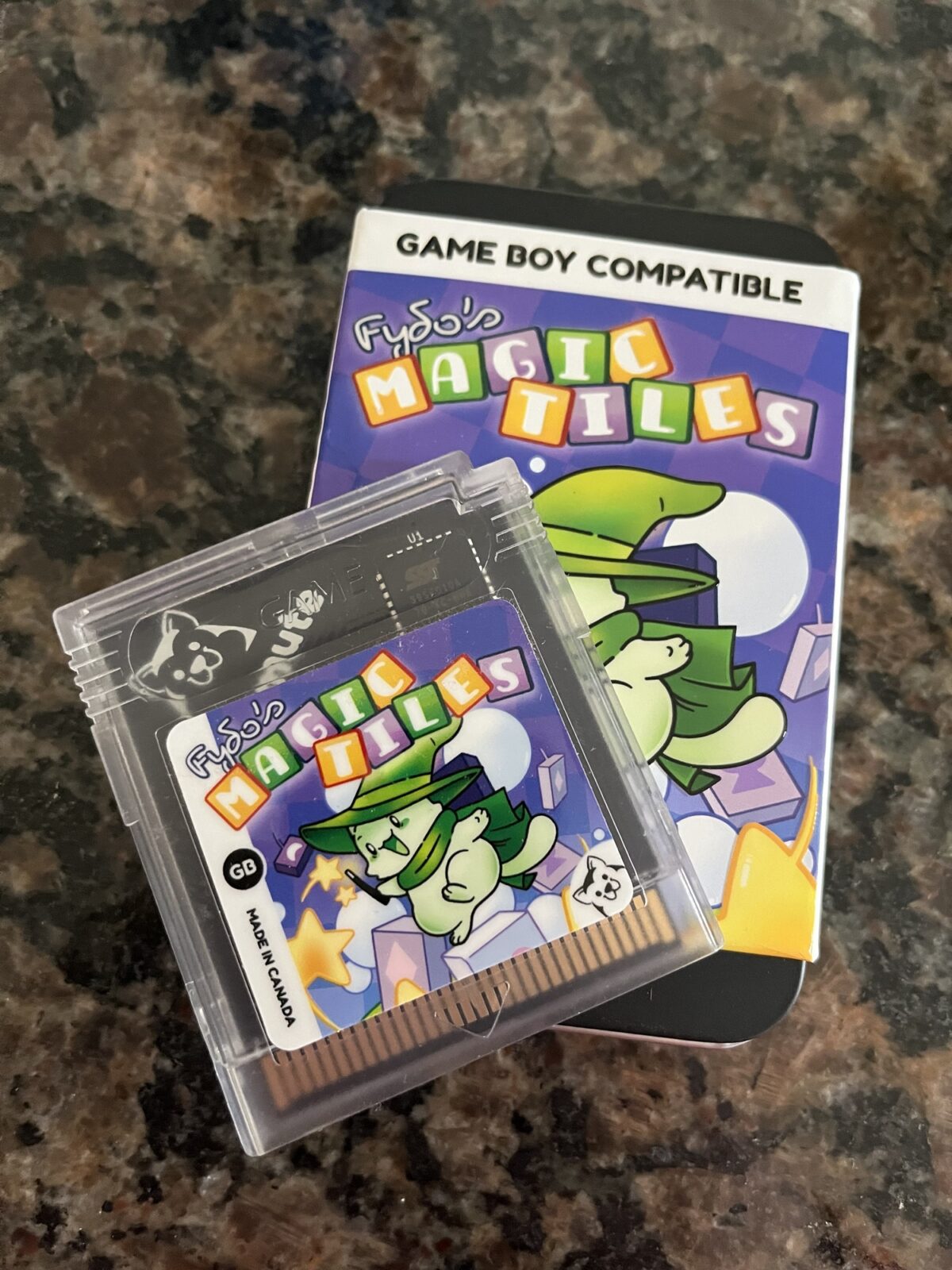 Fydo’s Magic Tiles GameBoy Cartridge atop the packaging it came in. 
