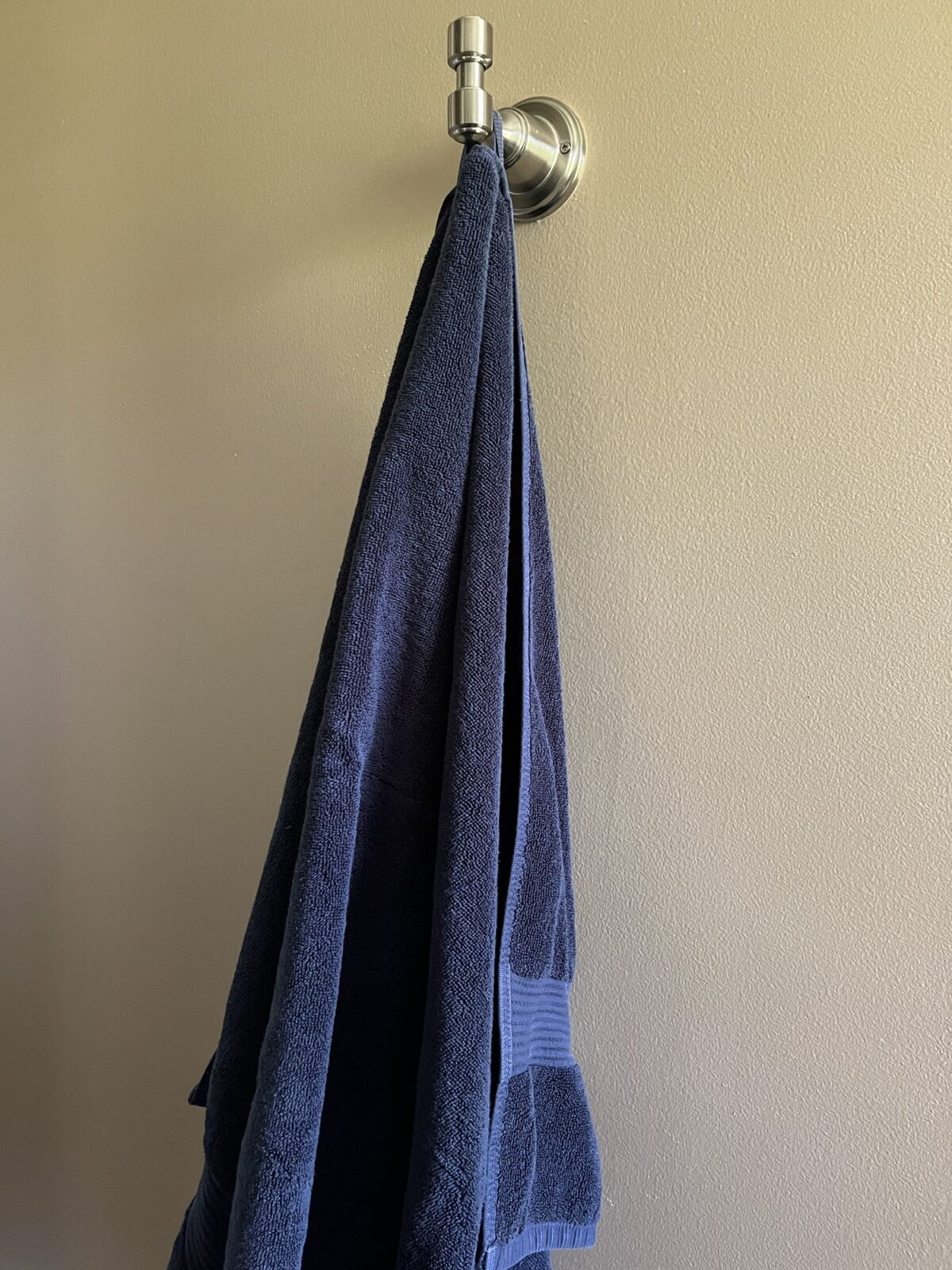 Blue towel hanging on a silver hook